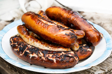 grilled sausages on the grill in the plate.