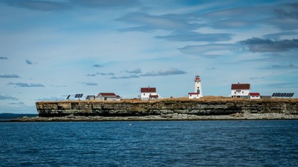 View of the lighthouse and adjacent buildings on Île aux Perroquets in Mingan Archipelago National Park Reserve.