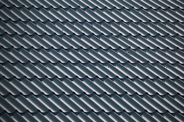 Blue textured tiles that cover the roof