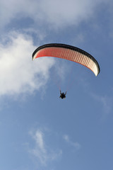 paraglider against the blue sky and white clouds