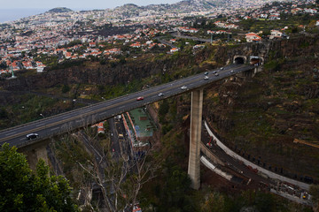 Big concrete bridge with cars crossing it and city in background, Madeira, Funchal