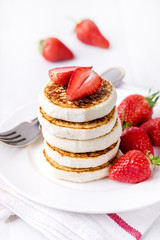 Stack of Tasty Homemade Cottage Cheese Pancakes with Strawberries on White Plate Tasty Healthy Diey Breakfast Breakfast Concept Vertical
