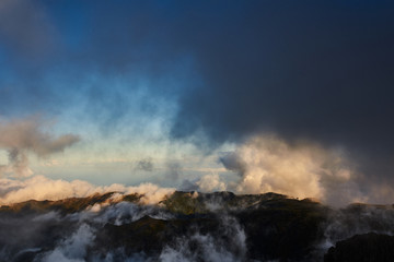 Mountain view from pico de arieiro with mountains, ocean, clouds and blue sky