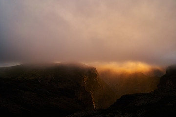 Mountain at sunset with gold clouds in Madeira,pico de arieiro
