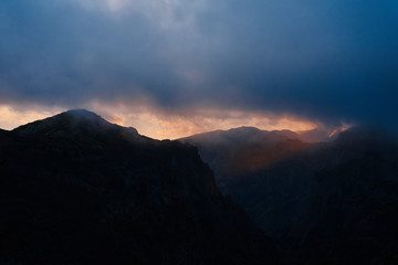 mountain in a cloudy day at sunset with blue sky