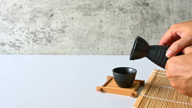 Asian men Pouring japanese sake oriental drink style Copy space,4K footage
