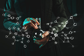 woman is a research scientist holding a flask with the material. Concept of scientific research and history of science. © Ulia Koltyrina