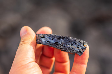Fragment of fresh lava in hand, Kamchatka Peninsula, Russia.