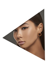 Cropped side geometric portrait of Asian lady with black flicks. The girl with dark hair is wearing blown stud earrings in the shape of flat ring, looking at the camera behind triangle foreground.
