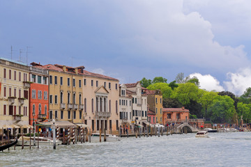 Canal and storm cloud over Venice, Italy. Venice postcard with Venice boats and architecture and landmarks of Venice.