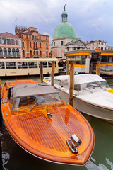 Canal and storm cloud over Venice, Italy. Venice postcard with Venice boats and architecture of Venice.