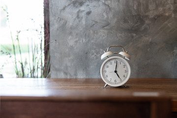 Vintage Clock on wooden table.