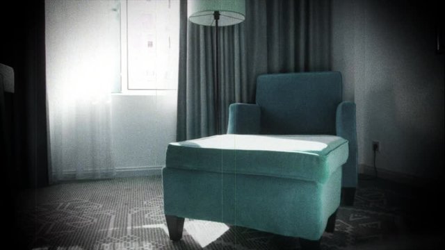 Slow focusing to cyan luxury velvet covered armchair in 5 star room hotel number with Azerbaijan traditional drawings on the carpet - vhs vintage tape film effect strong vignette 