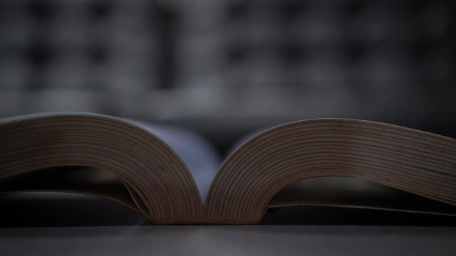 Open old textbook night light for reading in library or classroom on wooden lecture. copy space for text. Education for study learning in university concept. Classic tone, selective focus.