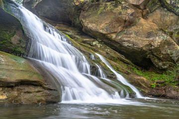 Fototapeta na wymiar Mountain river waterfall landscape. Stone cascade stream among rocks