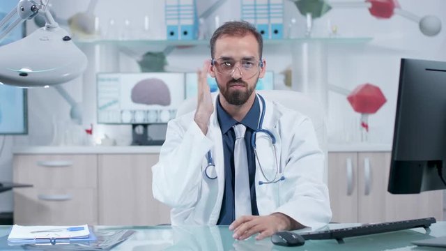 Surgeon at his desk wearing AR goggles and learing in virtual space about brain and DNA