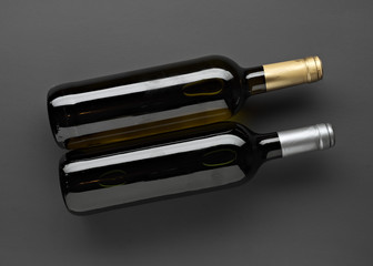 full bottles of spanish wine without labels on gray background