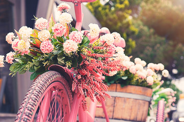 Rusty tricycle bike with flower pot in tray against blured background - Powered by Adobe