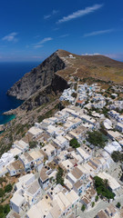 Aerial drone photo of picturesque main village (chora) of Folegandros island featuring uphill church of Panagia (Virgin Mary) built on top of steep hill overlooking the Aegean sea, Cyclades, Greece