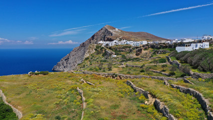 Aerial drone photo of picturesque main village (chora) of Folegandros island featuring uphill church of Panagia (Virgin Mary) built on top of steep hill overlooking the Aegean sea, Cyclades, Greece