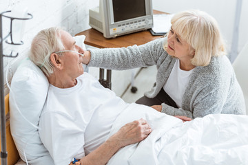 Fototapeta premium sad senior woman with sick husband in hospital