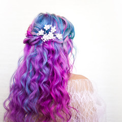 Beautiful and healthy hair with bright coloring. Long curly hair purple and pink tones