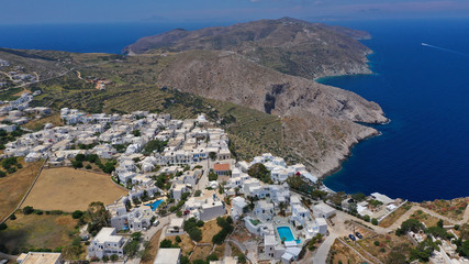 Fototapeta na wymiar Aerial drone photo of iconic and picturesque main village (chora) of Folegandros island featuring castle and built on top of steep hill overlooking the Aegean blue sea, Cyclades, Greece
