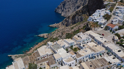 Naklejka premium Aerial drone photo of iconic and picturesque main village (chora) of Folegandros island featuring castle and built on top of steep hill overlooking the Aegean blue sea, Cyclades, Greece