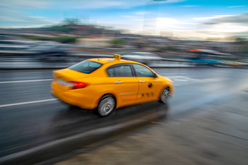 Obraz na płótnie Canvas Evening traffic long exposure yellow turkish taxi car on istanbul 