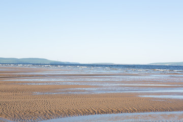 ocean waves lapping on the sandy beach