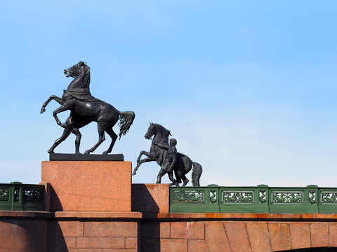 Anichkov Bridge in Saint Petersburg with sculptures of horses, sunny day