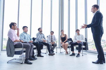 Group of business people having a meeting for new project planning. Manager standing and lead the annual sale meeting.