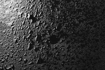 Water droplets on black background and  texture, top view