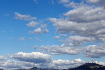 White sparse clouds over blue sky
