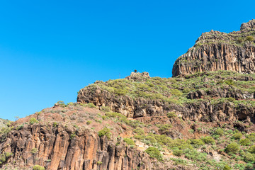 Fototapeta premium Hiking on La Gomera. In the mountains of the Valle Gran Rey on the Canary island La Gomera. The long distance trail leads to El Cercado, a mountain and pottery village in the highlands