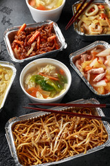 Chinese takeaway food. Pork Wonton dumpling soup, Crispy shredded beef, sweet and sour pineapple chicken, egg noodles with bean sprouts, curry.