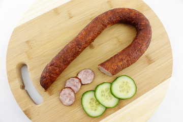sausages and cucumber on cutting board