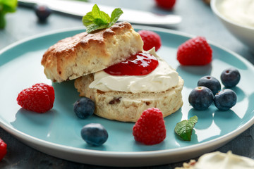 Classic English scones with clotted cream, strawberries jam and other fruit