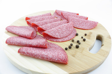 slices of salami on wooden board