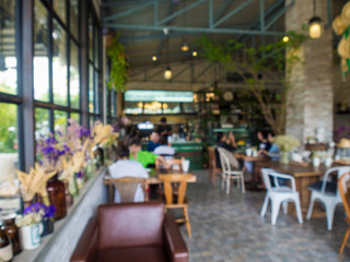 Fototapeta na wymiar Blurred indoor coffee shop with busy people