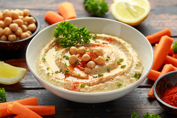 Hummus with olive oil, paprika, lemon and carrot.