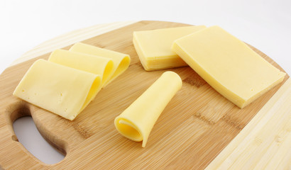 slices of cheese on a wooden board