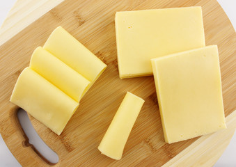 piece of cheese on a wooden board