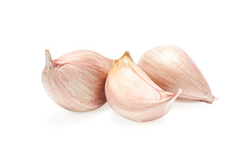 Three cloves of garlic isolated on a white background in close-up.