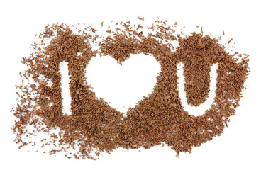 Text I love you made of grated chocolate isolated on white