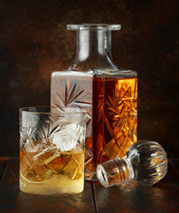 Crystal decanter and glass with whiskey and ice
