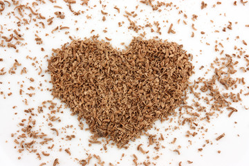 heart made of grated chocolate isolated on white