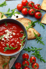 Grilled corn tortilla with sea salt flakes, spicy tomato salsa sauce and feta cheese