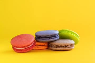 colorful macaroons isolated on yellow background. sweet biscuit. Traditional cake