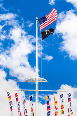 American,  POW  and colorful marine signal flags wave on pole at the central mall at Jones Beach...
